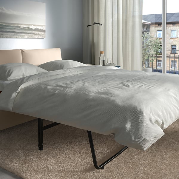 Modern grey sofa-bed with thick, comfy mattress; easily converts for sleeping.