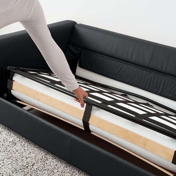 Person adjusting sofa-bed mechanism.
