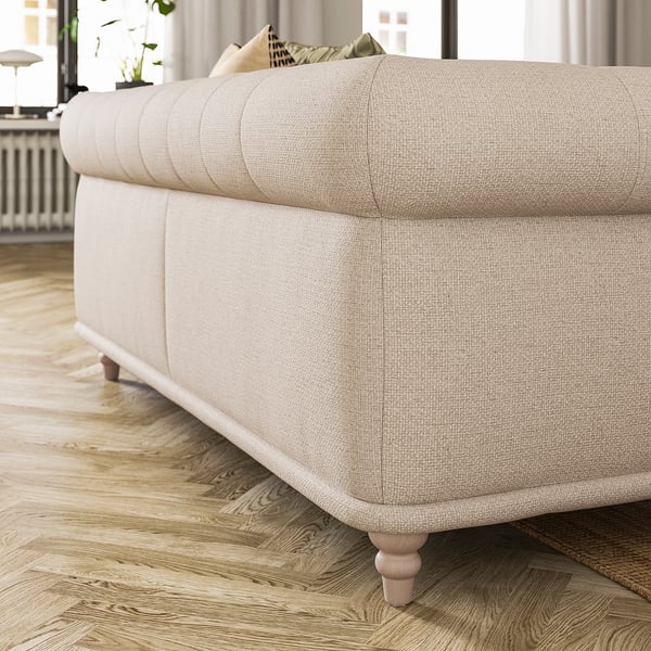 A VISKAFORS beige sofa with classic design and soft, rounded shapes. Its placed on a wooden floor.