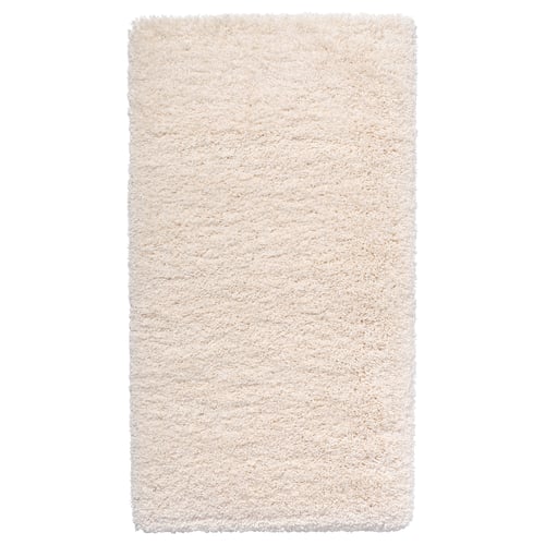 This is an a white, shaggy area rug with varying textures. Its rectangular and made from polypropylene.