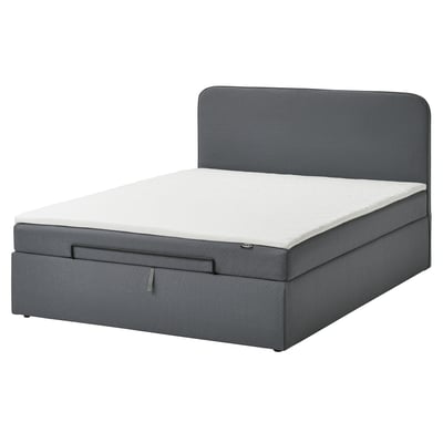 Blaues gepolstertes Schlafsofa mit verstecktem Stauraum und gepolstertem Kopfteil.