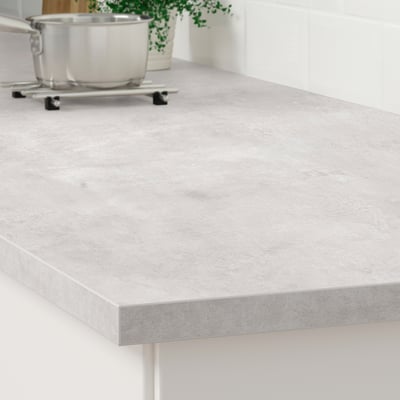 Eine schlanke, moderne Küchenarbeitsplatte mit glatter, grau laminierter Oberfläche. Es ist leicht zu reinigen und langlebig, perfekt für ein minimalistisches Design.