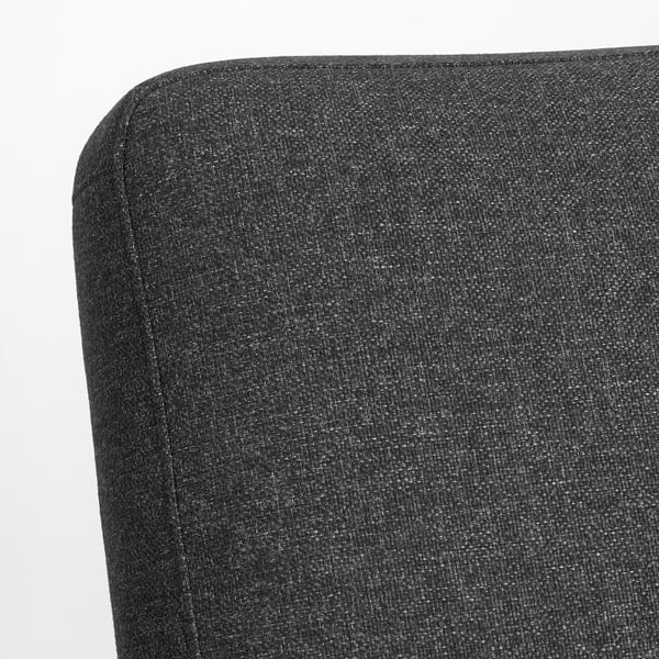 Nahaufnahme der EKENÄSET-Stühle aus schwarzem Plüschstoff mit glatten, gleichmäßigen Nähten und hochwertiger Polsterung.