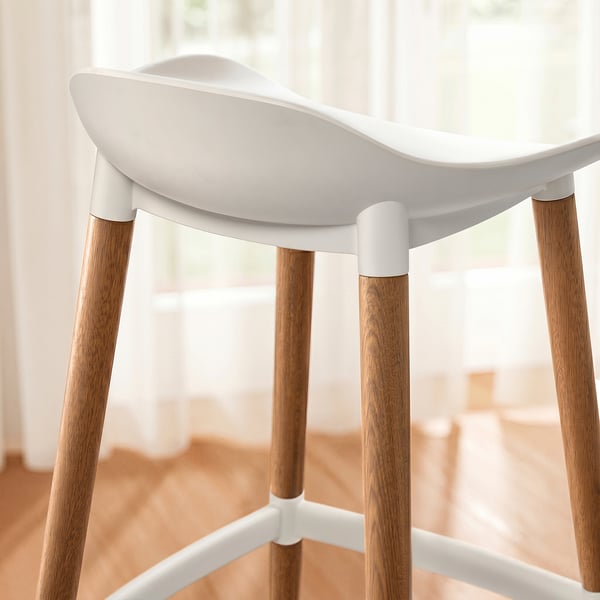 Moderner weißer Kunststoffhocker mit Holzbeinen für Innen- und Außenbereich, schlankes Design, bequemer Sitz.