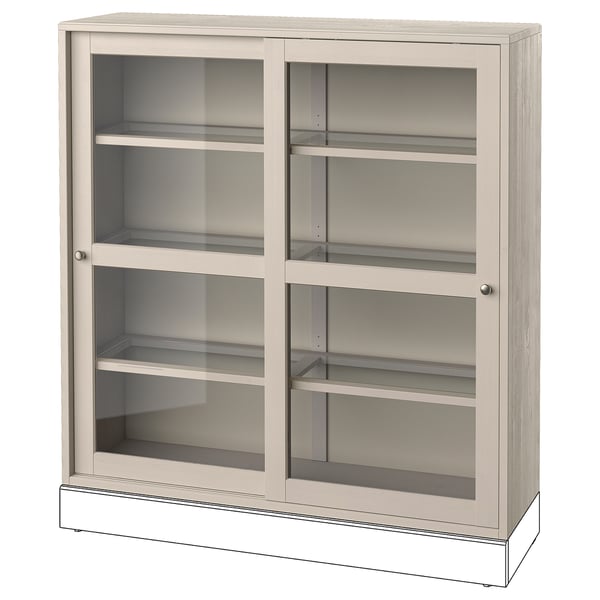 Ein hellbeiger Holzschrank von HAVSTA mit Glastüren und Regalen. Es hat eine rechteckige Form und ein schlankes Design, ideal für die staubfreie Präsentation von Gegenständen.