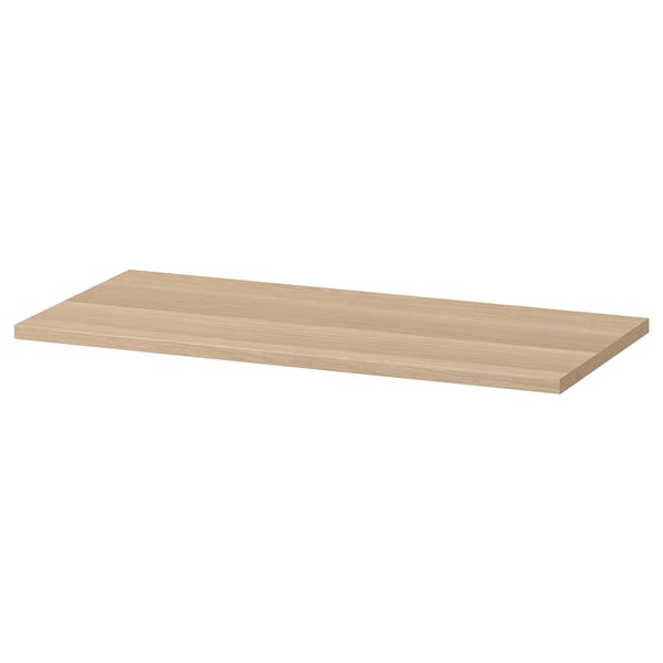 Ein flaches hellbraunes Holzregal mit dem Namen KOMPLEMENT. Es ist rechteckig mit glatten Kanten und einem einfachen Design.