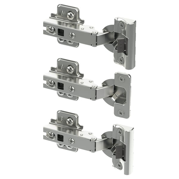 Drei silberne Metallscharniere mit Schrauben, die für Schranktüren entworfen wurden, sind in organisierter Weise sichtbar.