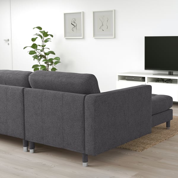 Modernes Wohnzimmer mit grauem Sofa, TV-Konsole und Wandkunst.