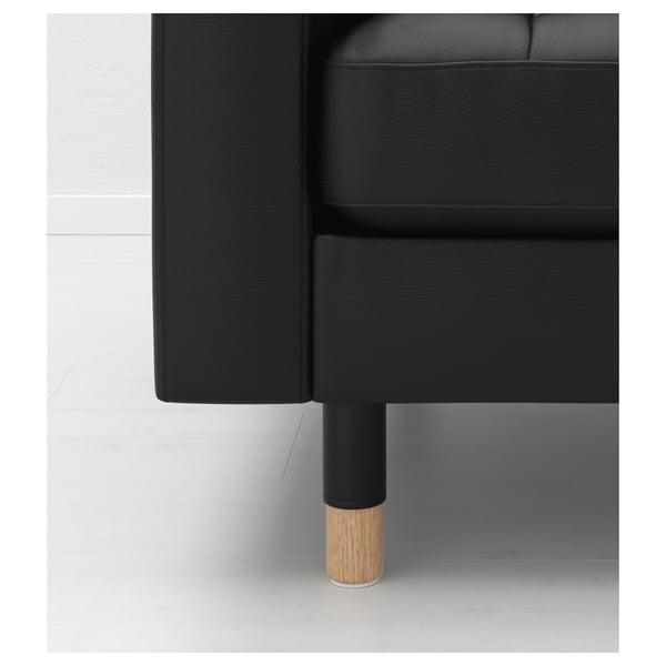 Schwarzes Sofa mit schlanken, polierten Holzbeinen, die Qualität und modernes Design betonen.