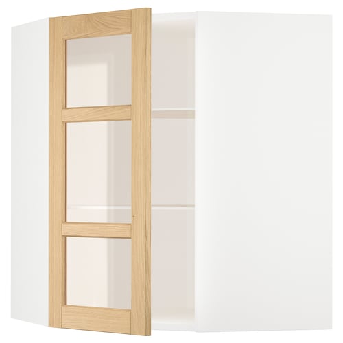 Ein weißer METOD-Küchenschrank mit Eichenverkleidung und Glastüren.
