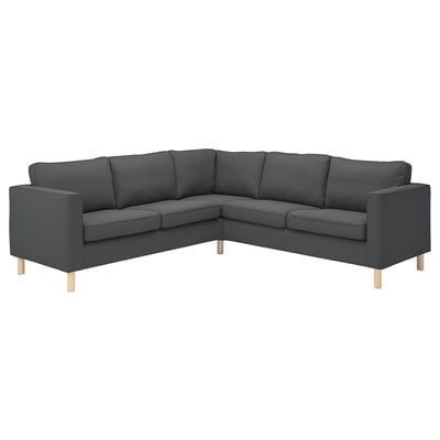 Ein dunkelgraues Ecksofa von PÄRUP mit breitem Cordbezug, hellen Holzbeinen und modernem, bequemem Design.