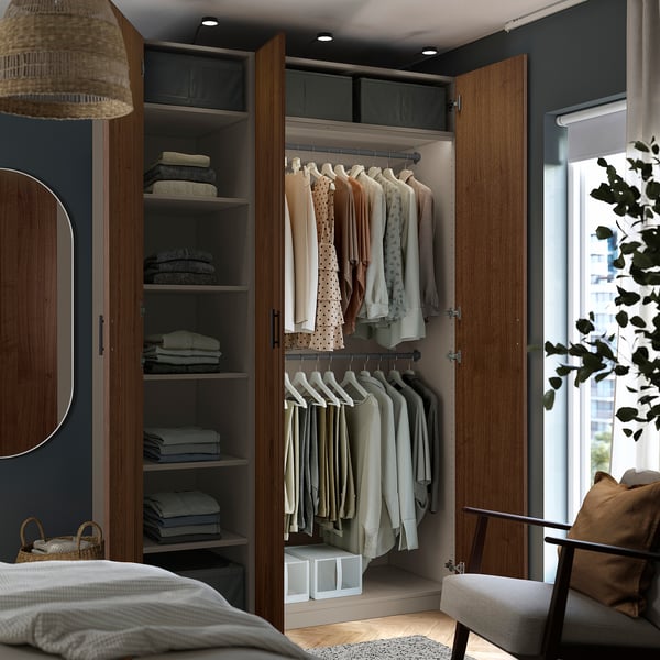 Modernes Schlafzimmer mit offenem Kleiderschrank mit Kleiderbügeln, Regalen mit gefalteten Kleidungsstücken und Aufbewahrungsboxen darunter.