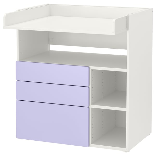 Zeigt einen weiß-violetten SMÅSTAD-Wickeltisch mit offenen Fächern. Mehrere Regale und Schubladen.