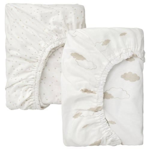 Two white baby bed sheets, one with dots, one with clouds, made of 100% cotton.