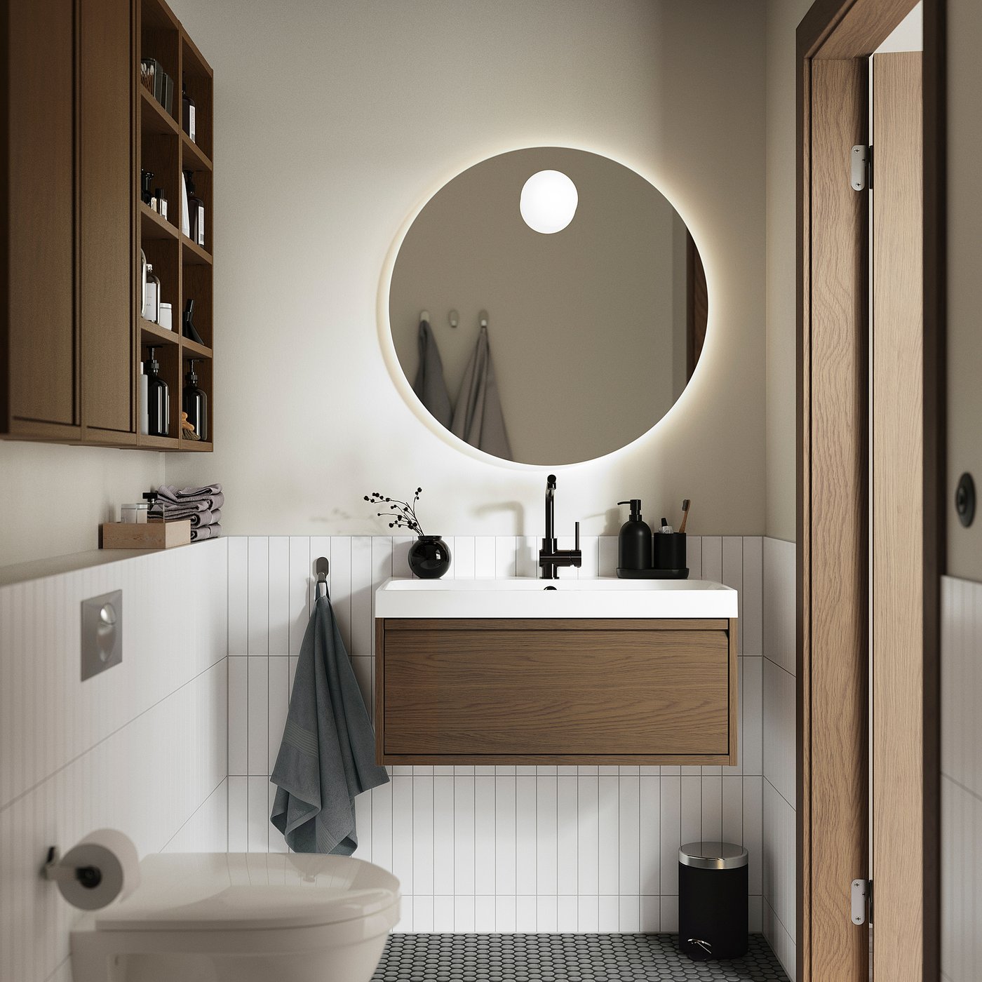 Modern bathroom with ÄNGSJÖN brown oak wash-stand, round mirror, white tiles, grey towels, and black accents.