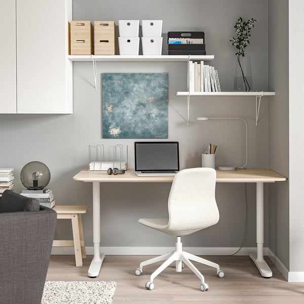Wall-mounted desk, chair, and shelves in modern home office.