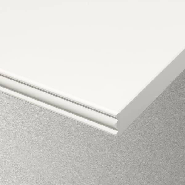 White wall shelf, sleek design with smooth and bevelled edges, set against plain wall. High-quality, minimalist style.