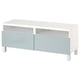 White and grey tv stand, minimalist design with 2 drawers, open compartments, and metal legs.