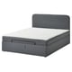 A BLÅFJÄLLET grey upholstered ottoman bed with a headboard and storage.