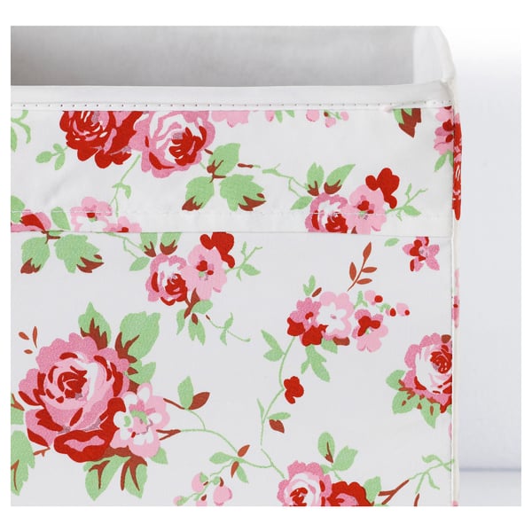 Floral-patterned storage box, neatly sewn, with sturdy handles, ideal for organising and storing items.