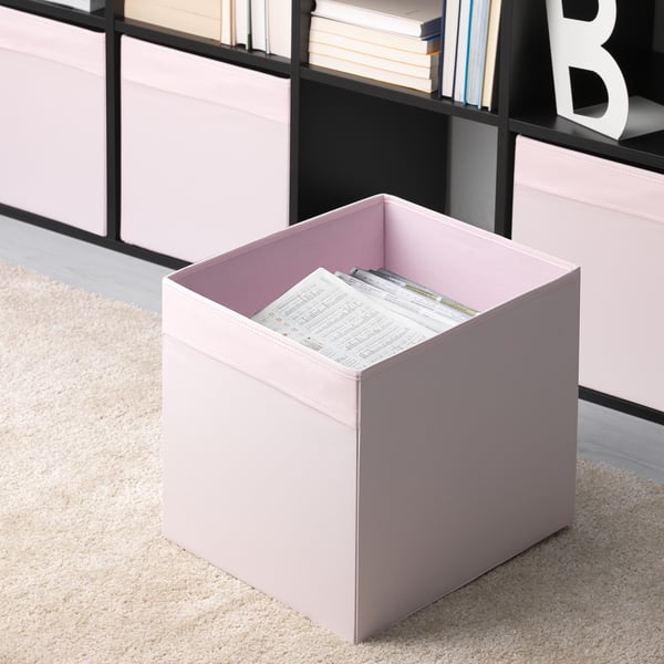 Beige storage boxes in fabric, one holding papers, in bookshelf. Perfect for organising. Part of DRÖNA series for kallax.