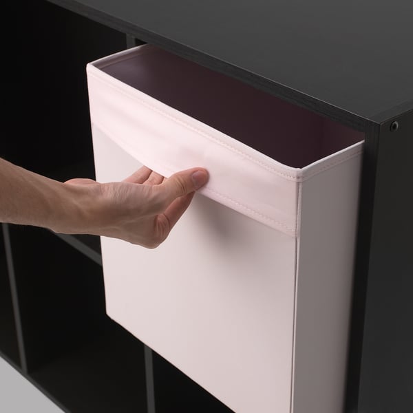 Hand pulling open a light pink storage box from a dark shelf, ideal for organised storage.