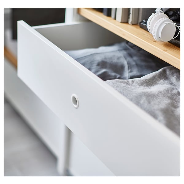 A white ELVARLI storage drawer with a partly visible grey fabric inside. The drawer is modern, minimalist, and part of an adjustable storage system.