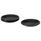 Image shows four black FÄRGKLAR ceramic plates, three stacked and one single, with a simple, round design.