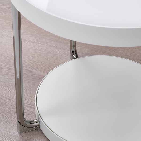 Modern glass-top table with chrome legs, showcasing elegant design and sturdy construction. Perfect for contemporary spaces.