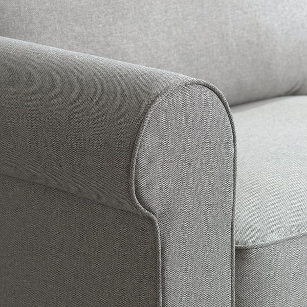 Close-up of a modern, sleek grey sofas armrest, showcasing smooth fabric texture and clean stitching.