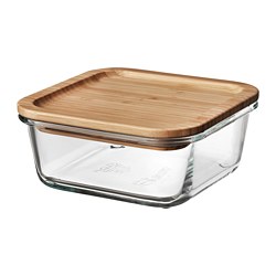 An IKEA 365+ glass food container with a wooden lid. Clear, square, with rounded corners, its great for storing and serving food.