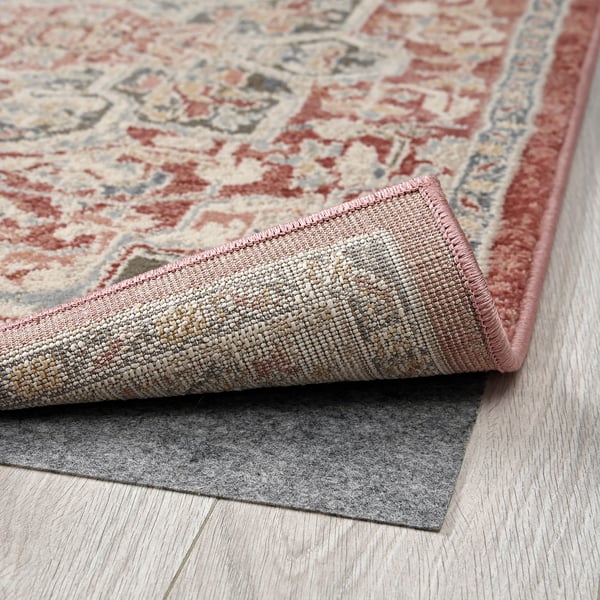 Elegant rug with intricate warm patterns, featuring durable materials for long-lasting use.