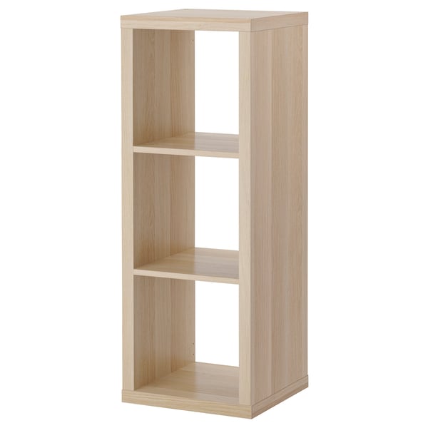The KALLAX shelving unit is light brown, made of particleboard with a rectangular shape and clean, minimalist design.