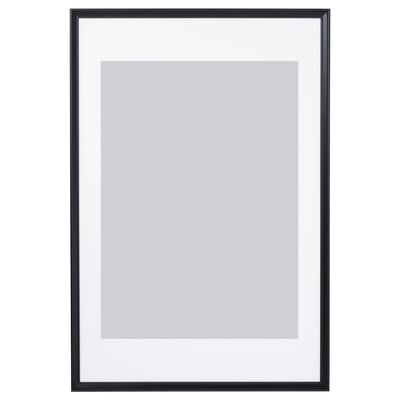 Black picture frame with white mat, suitable for wall or table display, has thin edge and plastic front protection.