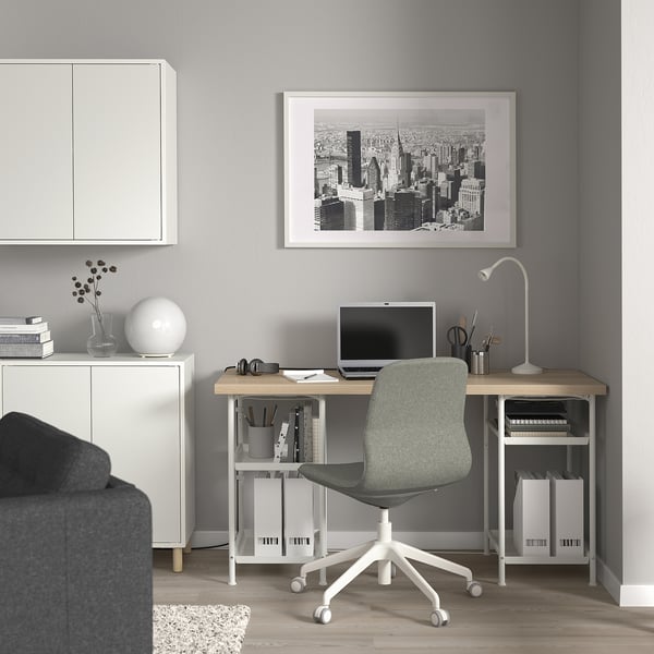 Modern minimalist home office with LAGKAPTEN desk, cityscape art, grey chair, and stylish accessories.