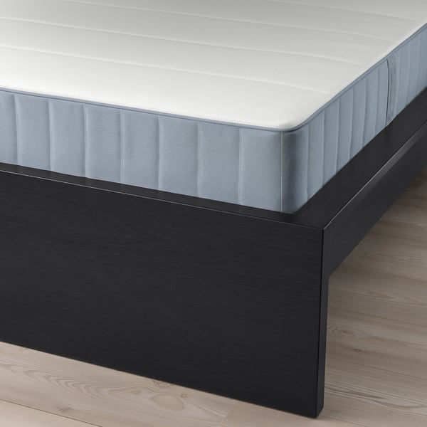 A modern bed with clean lines, wooden veneer, adjustable sides, and a high headboard for reading or tv.