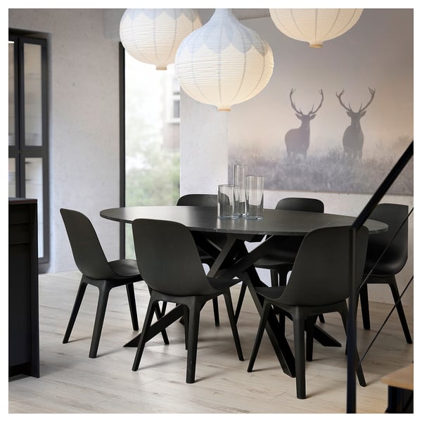 Modern kitchen/dining set with black marble table, four matching chairs, pendant lights, and a wall mural featuring two stags in a foggy forest.
