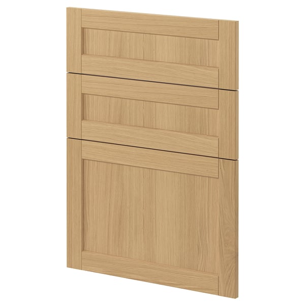 A light wooden cabinet door from ikeas METOD system, featuring oak veneer and beveled edges, designed for a classic kitchen look.