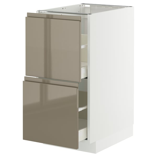 A modern kitchen cabinet named METOD with high gloss dark grey-brown voxtorp fronts. It sleek integrated handles and multiple drawers for storage.