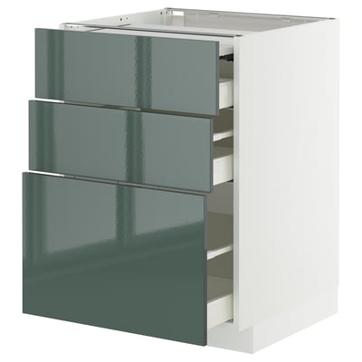 A modern kitchen cabinet with three gray-green glossy drawers and a white top.