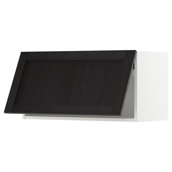 Modern black kitchen cabinet with bevelled edges and white frame.