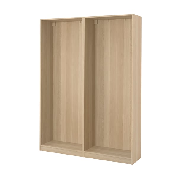 Light wood-colored PAX wardrobe frame with open compartments.