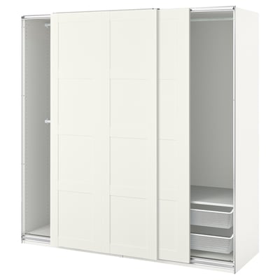 An off-white PAX wardrobe with sliding doors and two visible shelves.