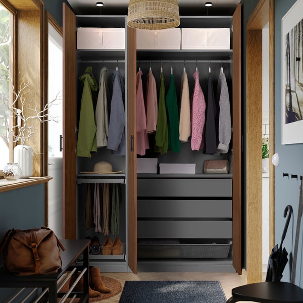 Open wardrobe displaying organised clothes, with drawers and storage solutions.