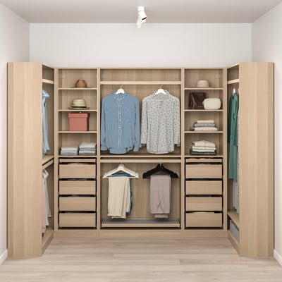 Well-organized wooden PAX closet with hanging shirts, folded clothes, and accessories. Lighting highlights stored items.