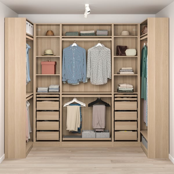 Well-organized closet with hanging shirts, folded clothes, and accessories on shelves and drawers.