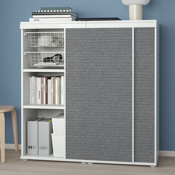 Bookshelf with sliding doors. Adjustable feet for floor levelling. Interior shelves and accessories for organised storage. Sliding doors save space.