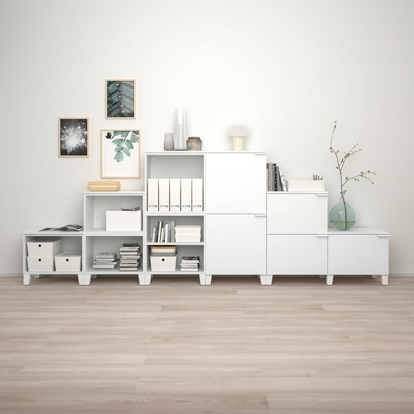 PLATSA storage units against grey wall, organized with various items.