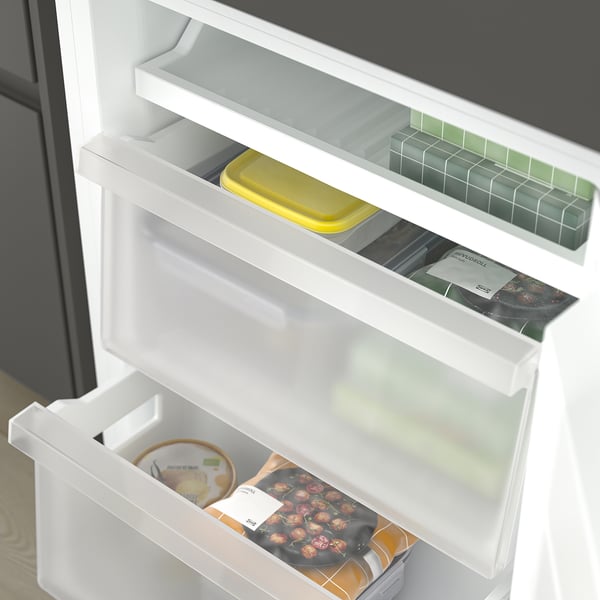 Fridge with adjustable shelves, yellow container, berries.
