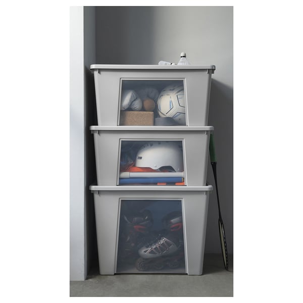 Three stacked grey SAMLA storage boxes with clear sides, storing sports gear.